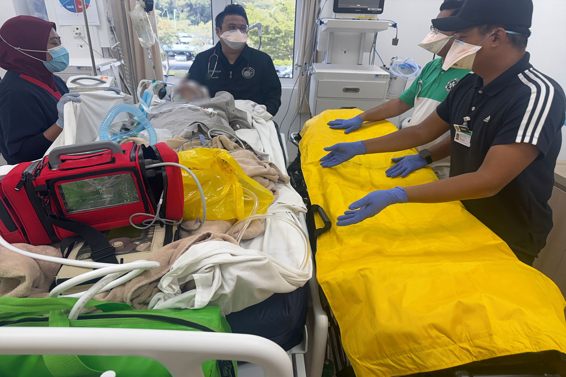 Medical team transporting a patient by ambulance